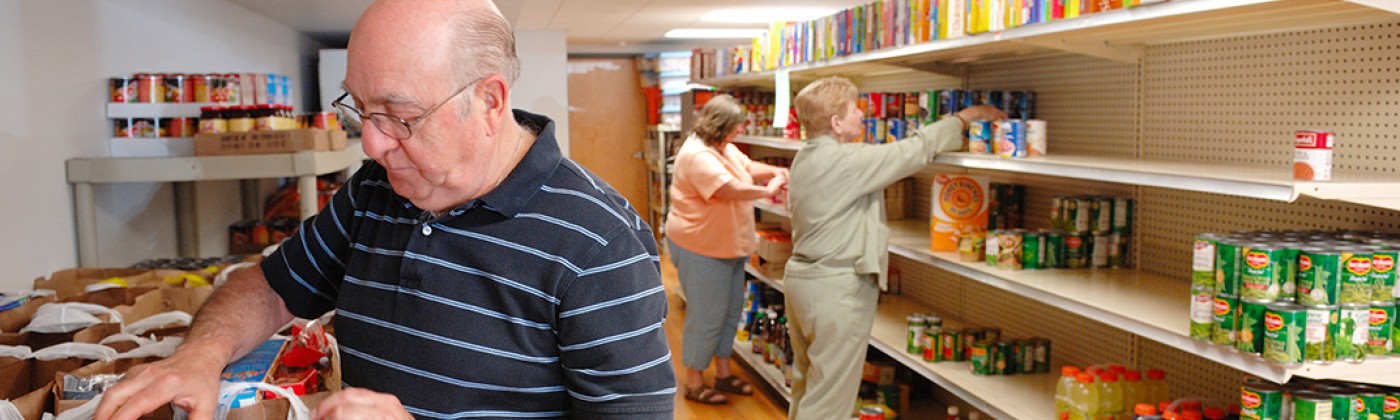 Three people shopping in a food pantry